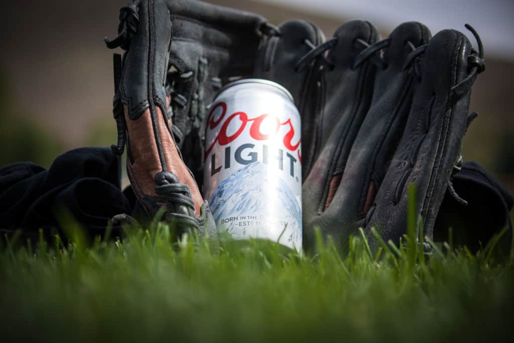 coors light can of beer in a baseball glove