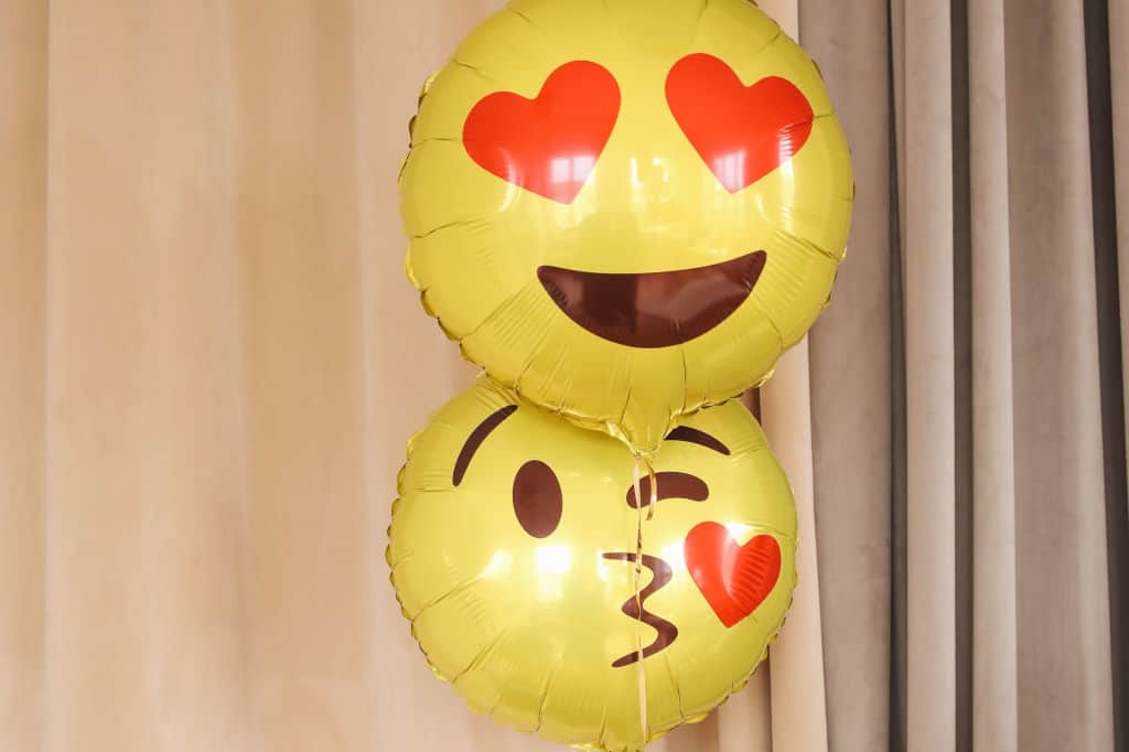two smiley foil balloons