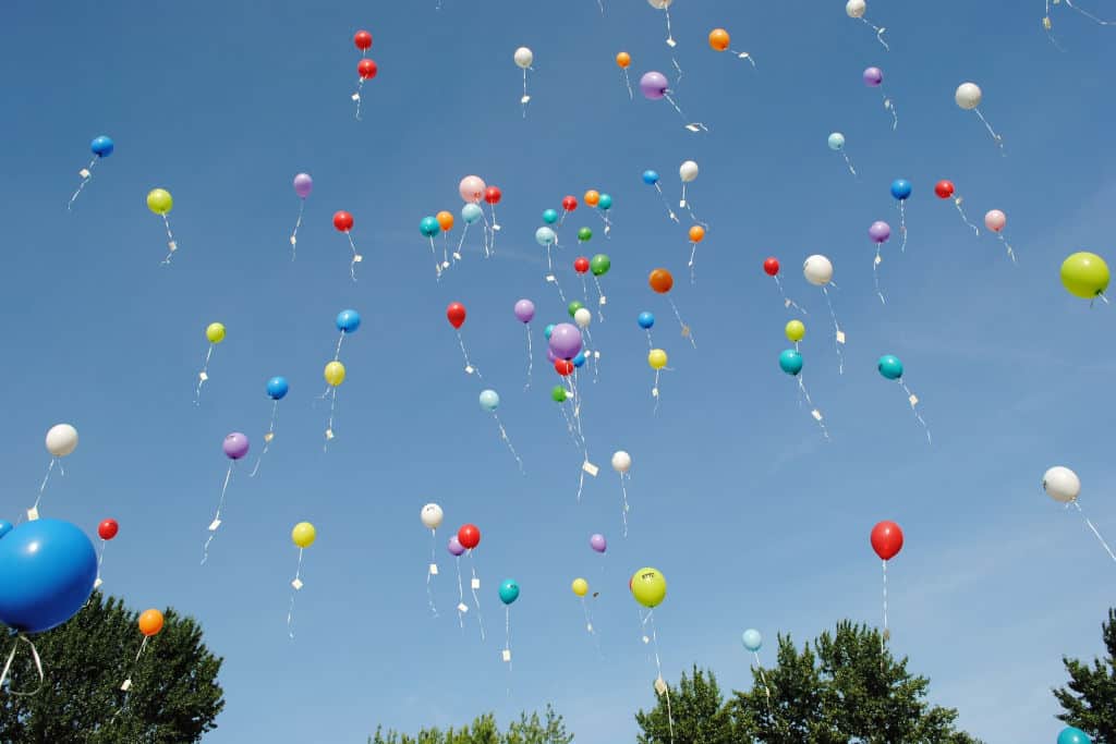 helium balloons floating in the sky
