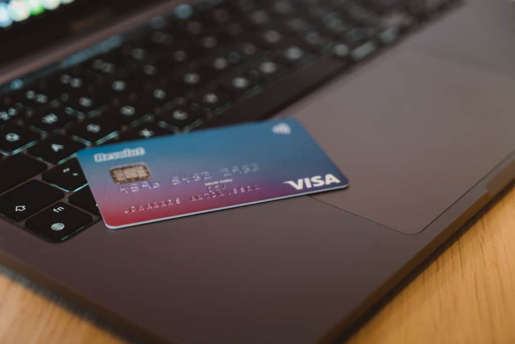 Visa credit-debit card on a grey laptop