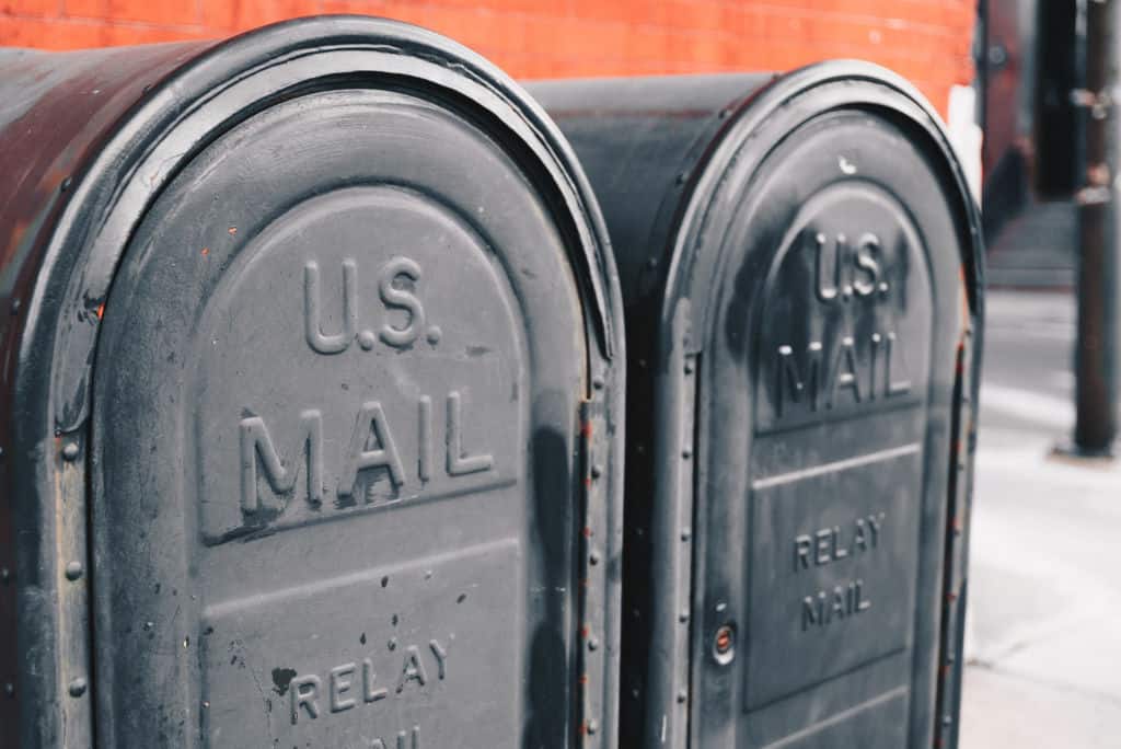 two gray US mailboxes close up