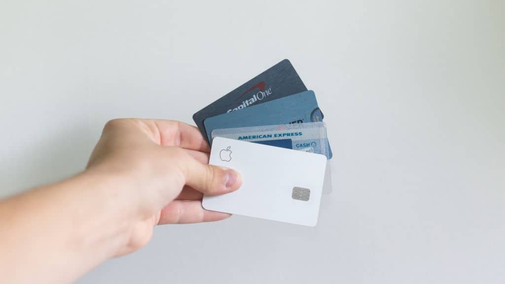 white and blue debit cards in hand