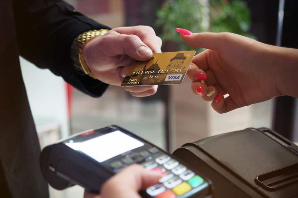 person paying on a terminal with a credit debit card