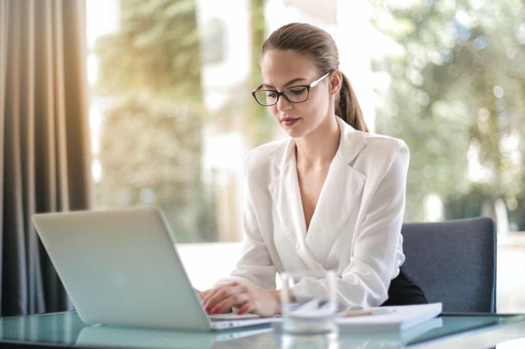 female typing on laptop in workplace
