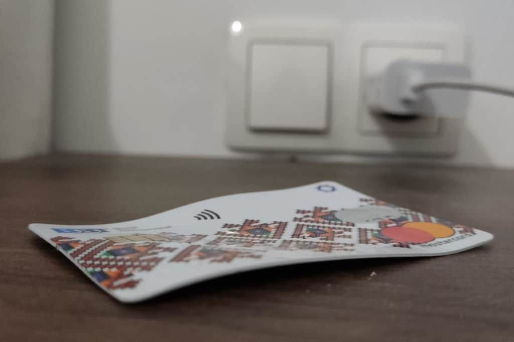 damaged bent debit card mastercard on the table